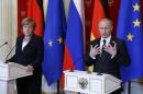 Putin and Merkel attend a news conference in Moscow