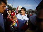 Venezuela's Vice President Nicolas Maduro greets supporters outside the military hospital after visiting President Hugo Chavez in Caracas