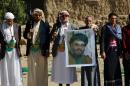 Huthi militiamen hold posters depicting Lebanon's Hezbollah chief Hassan Nasrallah to show their support to Hezbollah following the Gulf states' announcement declaring the group a "terrorist organization", in the capital Sanaa, on March 3, 2016
