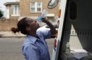 U.S. Postal Service letter carrier Monique Miller drinks from a bottle of water as she delivers mail in the Feltonville section of Philadelphia on Saturday July 7, 2012. Temperatures of more than 100 degrees were forecast in Philadelphia and excessive heat warnings were issued for several states in the Midwest as a heat wave continued. (AP Photo/Joseph Kaczmarek)