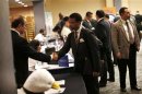 A job seeker meets with a prospective employer at a career fair in New York City