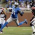 Detroit Lions wide receiver Calvin Johnson carries the ball between Atlanta Falcons safety Chris Hope and cornerback Dunta Robinson during the second half of their NFL football game in Detroit,
