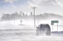 An SUV ventures past the St. Augusta, Minn., city limits sign on Stearns County Road 136 in near white-out conditions Sunday afternoon, Jan. 26, 2014 south of St. Cloud, Minn. An unusual weather pattern driving bitterly cold air from the Arctic Circle south across a huge swath of the Midwest is expected to send temperatures plummeting Monday from Minneapolis to Louisville, Ky., the latest punch from a winter that is in some areas shaping up as one of the coldest on record. (AP Photo/St. Cloud Times, Kimm Anderson) MANDATORY CREDIT