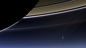 Handout of the wide-angle camera on NASA's Cassini spacecraft capturing Saturn's rings and planet Earth and its moon in the same frame