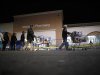 People push loaded shopping carts at a Walmart store, on Thanksgiving day in North Bergan