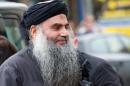 Radical Islamist cleric Abu Qatada arrives at his home in northwest London after he was released from prison on November 13, 2013