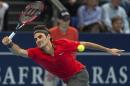 Switzerland's Roger Federer returns a ball to Bulgaria's Grigor Dimitrov during their quarterfinal match at the Swiss Indoors tennis tournament at the St. Jakobshalle in Basel, Switzerland, on Friday Oct. 24, 2014. (AP Photo/Keystone, Georgios Kefalas)