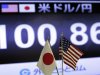 A screen indicates the current exchange rate of the U.S. dollar against Japanese yen behind the both countries' flags at a foreign exchange company in Tokyo, Friday,  May 10, 2013.(AP Photo/Itsuo Inouye)