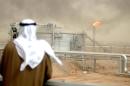 An employee of the Kuwait Oil Company (KOC) looks at the Al-Rawdatain oilfield, north of Kuwait City on January 25, 2005