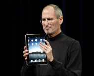 FILE - In this Jan. 27, 2010 file photo, Apple CEO Steve Jobs shows off the new iPad during an event in San Francisco. Imagine the potential treasures inside the stolen iPad of the late Steve Jobs, secret corporate documents, personal correspondence and maybe even game prototypes. Professional entertainer Kenny the Clown, who unwittingly received the stolen tablet after the Apple co-founder’s Palo Alto home was burglarized last month, says he never examined the touch-screen device’s contents. The San Jose Mercury News says Kenny the Clown, whose real name is Kenneth Kahn, had no idea the iPad came from the Jobs residence until a friend who gave it to him was charged with burglary and police had confiscated the device. Authorities say 35-year-old Kariem McFarlin stole iPods, Macs, jewelry and Jobs’ wallet. He is due in court Monday and recently hired a lawyer. (AP Photo/Paul Sakuma, File)