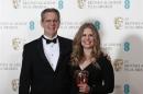 Chris Buck and Jennifer Lee celebrate after winning the Animated Film category for "Frozen" at the BAFTA awards ceremony in London