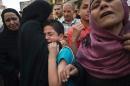 People react outside the courtroom in Minya on April 28, 2014 after a court sentences leader Mohamed Badie and other alleged Islamists to death