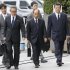 Olympus Corp.'s former President Tsuyoshi Kikukawa, front center, arrives with his lawyers at Tokyo District Court in Tokyo Tuesday, Sept. 25, 2012.  Kikukawa admitted guilt Tuesday in a cover-up scandal of massive investment losses at the major Japanese camera and medical equipment company. (AP Photo/Kyodo News) JAPAN OUT, MANDATORY CREDIT, NO LICENSING IN CHINA, FRANCE, HONG KONG, JAPAN AND SOUTH KOREA