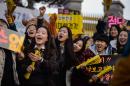 Outside test centres in Seoul, junior students held good-luck banners and shouted encouragement as their seniors entered the exam room