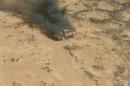 Handout photo of a pickup truck on fire after it was hit by a Jordanian warplane following failure to heed warnings not to cross into Jordan from Syria