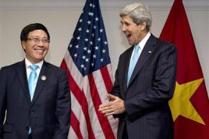 U.S. Secretary of State John Kerry and Vietnam's Foreign Minister Pham Binh Minh smile during an ASEAN meeting in Bandar Seri Begawan