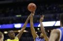 Kentucky's Aaron Harrison (2) shoots a three-point basket past Michigan's Caris LeVert (23) in the final second of the second half of an NCAA Midwest Regional final college basketball tournament game Sunday, March 30, 2014, in Indianapolis. Kentucky won 75-72. (AP Photo/David J. Phillip)