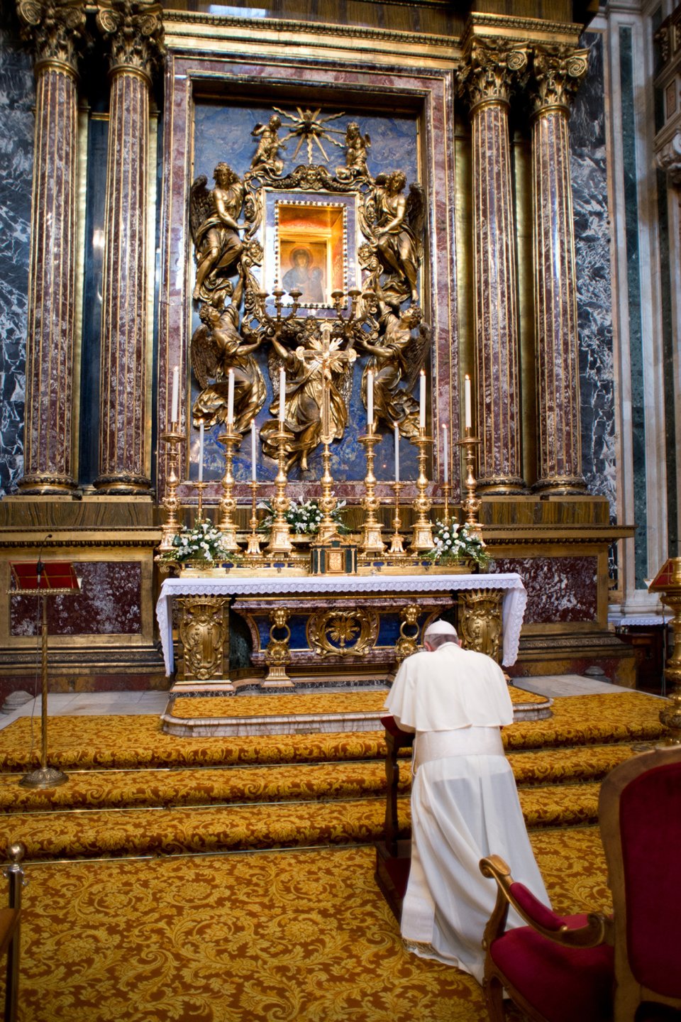In this photo provided by the Vatican newspaper L'Osservatore Romano, Pope Francis prays in Rome's St. Mary Major Basilica he unexpectedly visited in view of his upcoming trip to Brazil to celebrate the World Youth Day, Saturday, July 20, 2013. Francis leaves Monday, July 22 for Rio de Janeiro, where more than a million young Catholics are expected to celebrate their new pope. The 76-year-old Argentine became the church's first pontiff from the Americas in March, and the trip to Brazil is his first international journey since becoming pontiff. Catholic youth festivals are meant to reinvigorate the faithful, and Francis is expected to inspire young people with his humble ways. (AP Photo/L'Osservatore Romano, ho)