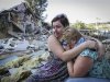 Samokhval, daughter of Khlystov, embraces her crying mother in front of their partially demolished house in the Black Sea city of Sochi