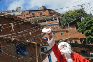 A man dressed as Santa Claus greets people during "Santa …