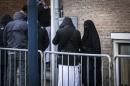 People arrive at the courthouse in Amsterdam on December 10, 2015 ahead of the verdict of eight men and one woman charged with belonging to a network recruiting young Muslims to join the Islamic State jihadist group