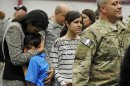 South Carolina Gov. Nikki Haley, left, comforts her son, Nalin, 10, and her daughter, Rena, 14, as her husband, Capt. Michael Haley, right, gets ready for a deployment ceremony for the South Carolina Army National Guard 3/49 Agribusiness Development Team at McCrady Training Center, Thursday, Jan. 10, 2013, at Ft. Jackson, S.C. The deployment is scheduled for a year including one month of training in Indiana prior to leaving for Afghanistan. (AP Photo/Rainier Ehrhardt)