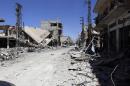 Ruins are seen at al-Qaryatain city in the central city of Homs, Syria on Monday, April 4, 2016. Syrian troops and allied militiamen pressed on with an offensive against Islamic State militants in central Syria on Monday, clashing with the extremists around the town of Qaryatain a day after it was captured by pro-government forces. The Obama administration says Iran is drawing down its elite fighting force from Syria, yet Iran is still taking casualties and Tehran said Monday it has dispatched commandos to the war despite a partial cease-fire that took effect a month ago. (AP Photo)