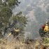 Firefighters from the Granite Mountain Hotshots of Prescott, Ariz., cut a fire line along a mountain ridge outside Mogollon, N.M., on Saturday, June 2, 2012. The crew is part of an effort to manage and contain the Whitewater-Baldy fire which has burned more than 354 square miles of the Gila National Forest in New Mexico.  (AP Photo/U.S. Forest Service, Tara Ross)