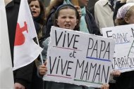 A young girl walks with Christian fundamentalists from the Civitas Institute who attend a protest march called, "La Manif pour Tous" (Demonstration for All) against France's legalisation of same-sex marriage, in Paris, May 26, 2013. Placards read, "Long Live Papa, Long Live Mom". REUTERS/Pascal Rossignol