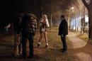 French police speak to a prostitute (centre) and to a client (left) during an anti-prostitution operation in the Bois de Boulogne district of Paris, on March 2, 2012