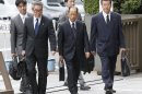 Olympus Corp.'s former President Tsuyoshi Kikukawa, front center, arrives with his lawyers at Tokyo District Court in Tokyo Tuesday, Sept. 25, 2012. Kikukawa admitted guilt Tuesday in a cover-up scandal of massive investment losses at the major Japanese camera and medical equipment company. (AP Photo/Kyodo News) JAPAN OUT, MANDATORY CREDIT, NO LICENSING IN CHINA, FRANCE, HONG KONG, JAPAN AND SOUTH KOREA