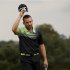 Sergio Garcia of Spain tips his hat to the crowd after sinking a par putt on the 18th green during first round play in the 2013 Masters golf tournament in Augusta