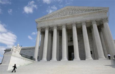 Security guards walk the steps of the Supreme Court in Washington, October 1, 2010. REUTERS/Larry Downing