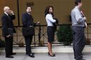 People wait in line to enter a job fair in New York