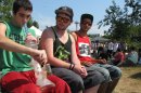 Matt Galanti, 17, of Bothell, Wash., smokes marijuana from a glass bong at the opening day of the pro-marijuana rally Seattle Hempfest, Aug. 17, 2012, as friends Zach Casselman, 18, of Bothell, and Clay Graeber, 20, of Bothell, look on. Organizers expected more than 150,000 people to attend the three-day event, which comes as citizens in Washington state prepare to vote on an initiative that would legalize and tax the sale of up to an ounce of cannabis at state-licensed stores. (AP Photo/Gene Johnson)