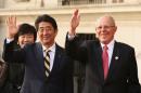 Japanese Prime Minister Shinzo Abe and Peru's President Pedro Pablo Kuczynski wave as they meet at the presidential palace ahead of the 2016 APEC (Asia-Pacific Economic Cooperation) summit in Lima