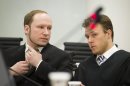 Confessed mass-murderer Anders Behring Breivik talks with his Tord Jordet, one of Breivik's lawyers inside court as the trial against him continues in Oslo, Norway, Tuesday May, 29, 2012. Three former friends of Breivik gave evidence Tuesday about his deep depression, living with his mother and his lack of social contacts while Breivik watched from an adjoining room. The terror trial continues against the anti-Muslim fanatic, Breivik, who has confessed to killing 77 people in July 2011, when he 8 people by setting off a bomb in central Oslo, and then shot to death 69 people on Utoya island, outside the Norwegian capital. (AP Photo / Heiko Junge, NTB scanpix) NORWAY OUT