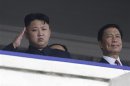 North Korean leader Kim Jong-un salutes next to China's Vice President Li Yuanchao during a parade in Pyongyang