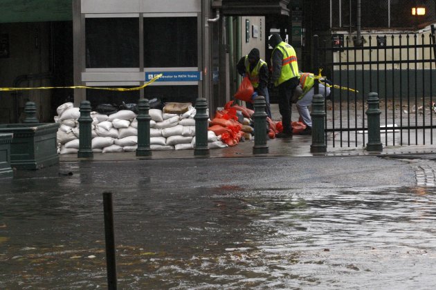 Workers place sandbags at the Path Station as it starts to get flooded in Hoboken while Hurricane Sandy approaches to New Jersey