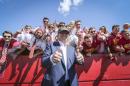 Republican presidential candidate Donald Trump poses for a photo with Iowa State fans before an NCAA college football game between Iowa State and Iowa, Saturday, Sept. 12, 2015, in Ames, Iowa. (Rodney White/The Des Moines Register via AP) MAGS OUT, TV OUT, NO SALES, MANDATORY CREDIT