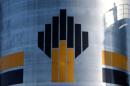 Shadow of worker is seen next to logo of Russia's Rosneft oil company at central processing facility of Rosneft-owned Priobskoye oil field outside Nefteyugansk