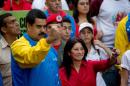 FILE - In this Oct. 18, 2014 file photo, Venezuela's President Nicolas Maduro and first lady Cilia Flores, greet supporters as they arrive for a march for peace in Caracas, Venezuela. Two nephews of Venezuela's powerful first lady Cilia Flores were arrested in Haiti on charges of conspiring to smuggle 800 kilograms of cocaine into the U.S. and will be arraigned in New York, three people familiar with the case said Wednesday, Nov. 11, 2015. (AP Photo/Fernando Llano, File)