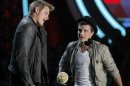 Actors Alexander Ludwig and Josh Hutcherson accept the award for best fight for their role in "The Hunger Games" at the 2012 MTV Movie Awards in Los Angeles