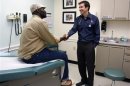 Chief Medical Officer of Whitman-Walker Health Dr. Raymond Martins welcomes patient Eddie Jones, of Washington, in Washington