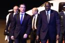 French Prime Minister Manuel Valls (L) is welcomed by Mali's Prime Minister Modibo Keita (R) at Bamako International Airport on February 18, 2016