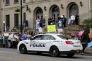 People cheer as a Malone police vehicle passes by during a rally in support of law enforcement following the capture of David Sweat, in Malone