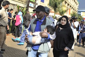A rescue worker helps a child outside the Westgate …