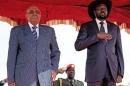 Sudan's President Omar al-Bashir (L) stands beside South Sudan's President Salva Kiir during a welcoming ceremony at Juba airport on October 22, 2013