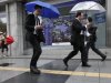 Men check their mobile phones as they walk by an electronic stock indicator in Tokyo Tuesday, May 15, 2012. Asian stock markets were mostly lower Tuesday, rattled by a political impasse in Greece that could lead the debt-stricken country to a destabilizing exit from the euro currency union. Japan's Nikkei 225 index fell 73.10 points, or 0.81 percent, to close at 8,900.74, a new three-month low. (AP Photo/Shizuo Kambayashi)