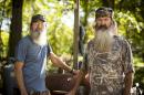 This undated image released by A&E shows brothers Silas "Uncle Si" Robertson, left, and Phil Robertson from the popular series "Duck Dynasty." Phil Robertson was suspended for disparaging comments he made to GQ magazine about gay people but was reinstated by the network on Friday, Dec. 27. In a statement Friday, A&E said it decided to bring Robertson back to the reality series after discussions with the Robertson family and "numerous advocacy groups." (AP Photo/A&E, Zach Dilgard)